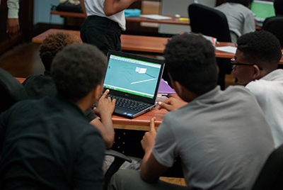 students participating in computer activity during sustainability course