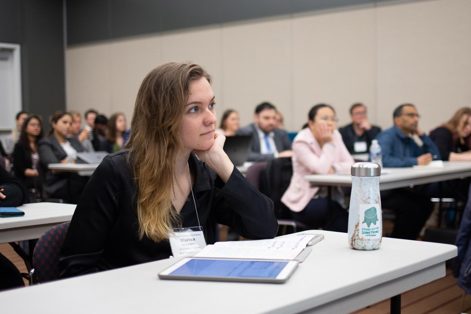 Conference attendee watching a presentation