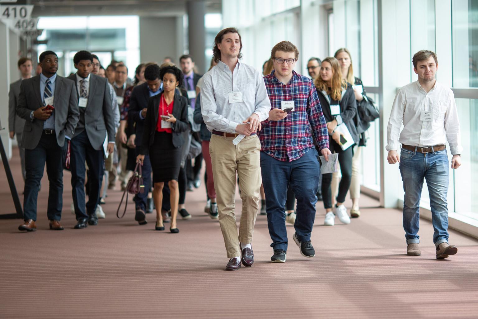 Conference participants walking in hallway