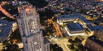 View of Pitt campus from drone above Cathedral of Learning at night