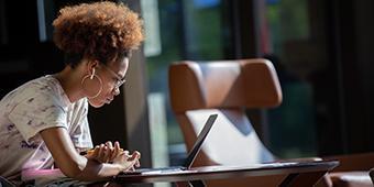 female student studying with laptop