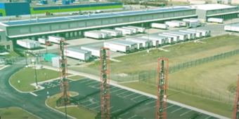 aerial view of shipping trucks in a lot outside of a warehouse